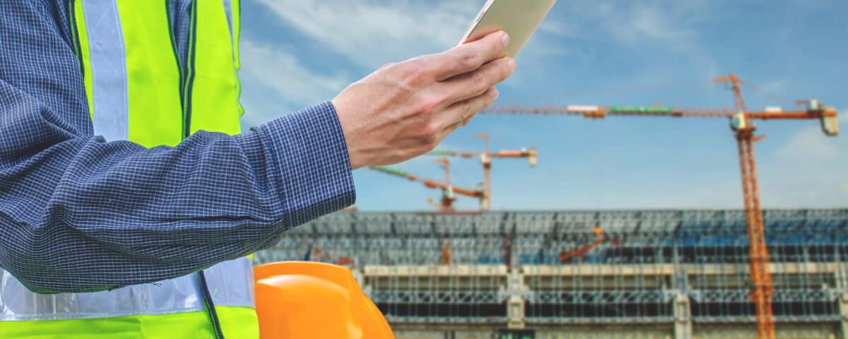 man at a construction site with tablet