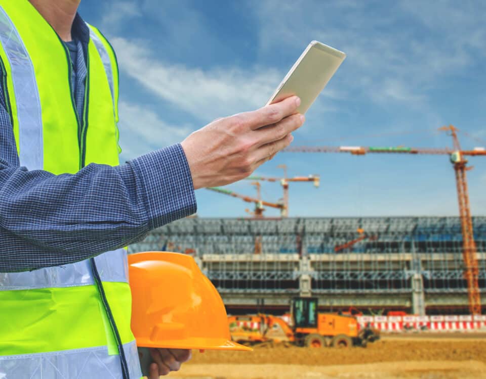 man at a construction site with tablet